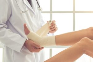 Doctor applies Unna Boot on patient